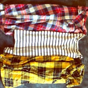 two flannels and one striped shirt.